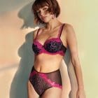 Model wearing Marie Jo Adelade collection bra and brief set in pink, purple and black