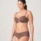 Model wearing Prima Donna bra and brief set in brown and gold tones